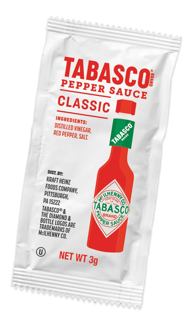 TABASCO packet being squeezed onto fries adding instant heat and improved taste