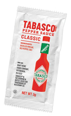 TABASCO packet being squeezed onto fries adding instant heat and improved taste