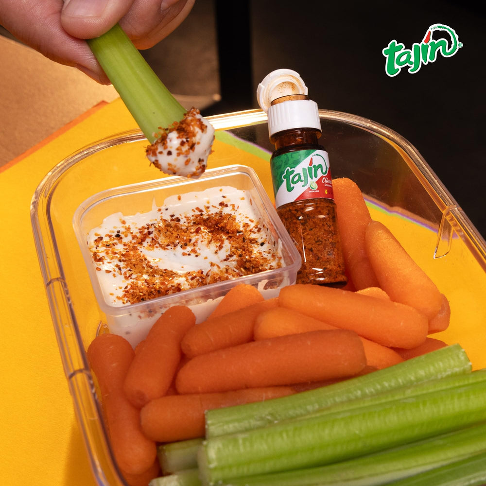 Tajín mini pouch open shaker top displaying controlled sprinkle for portioning