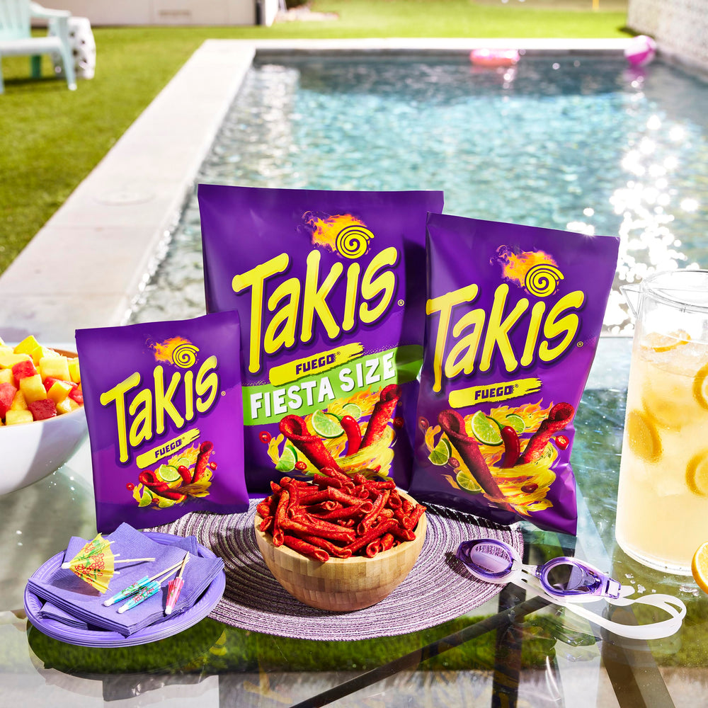 Close-up of Takis Fuego seasoning, displays intense chili and lime coating for bold flavor