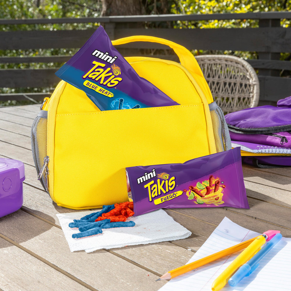 Takis mini bag held in hand to show compact size and easy portability