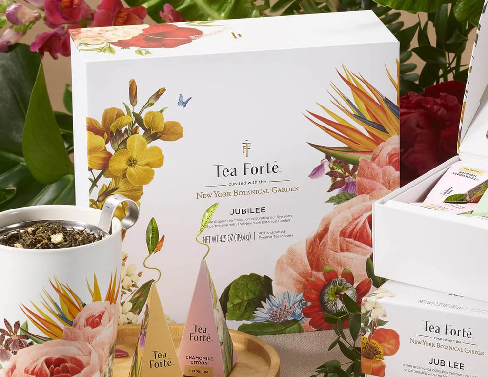 Tea Forté assorted pyramid sachets spread on wood showing variety and selection