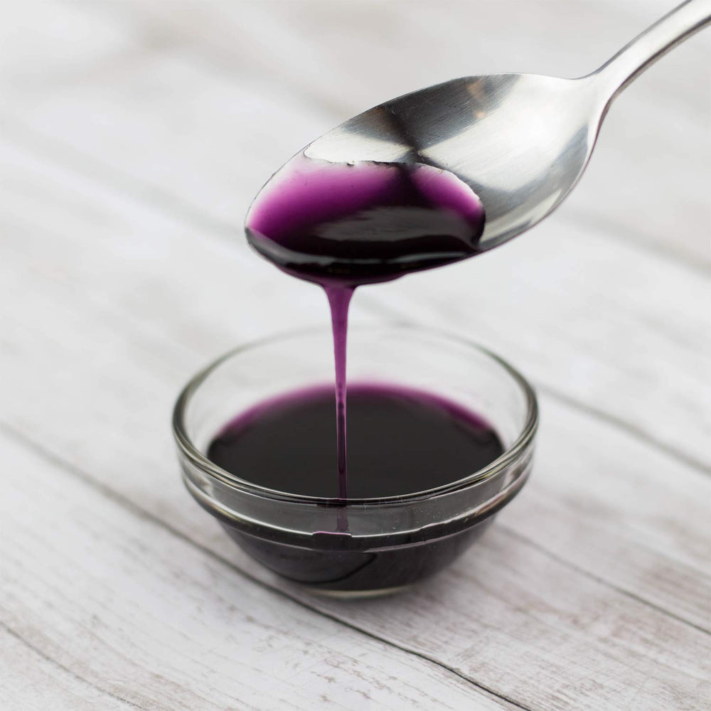 Tea Zone blueberry syrup used in a slush cup highlighting vibrant color and appeal