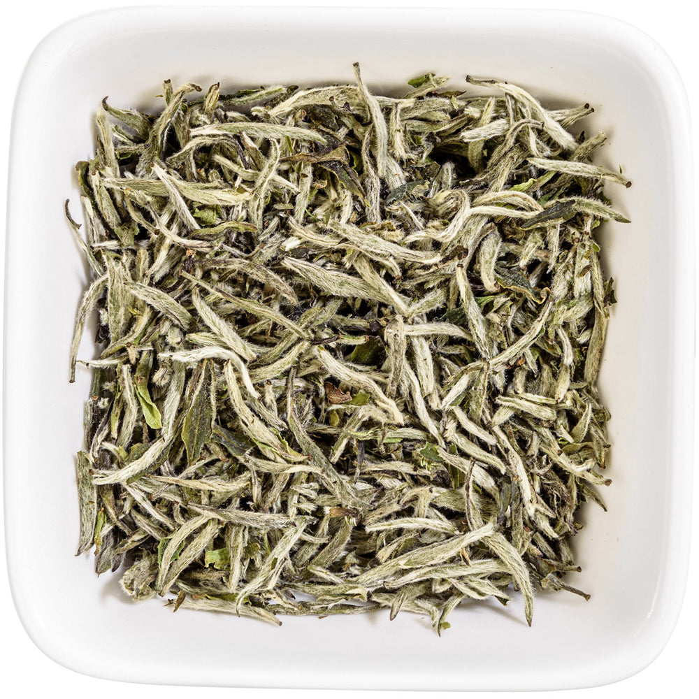 Tealyra loose leaves beside measuring spoon showing 110g scale and serving size
