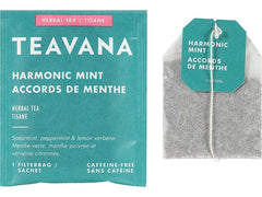 Teavana tea bag steeping in cup with mint leaves, shows infusion color and aroma