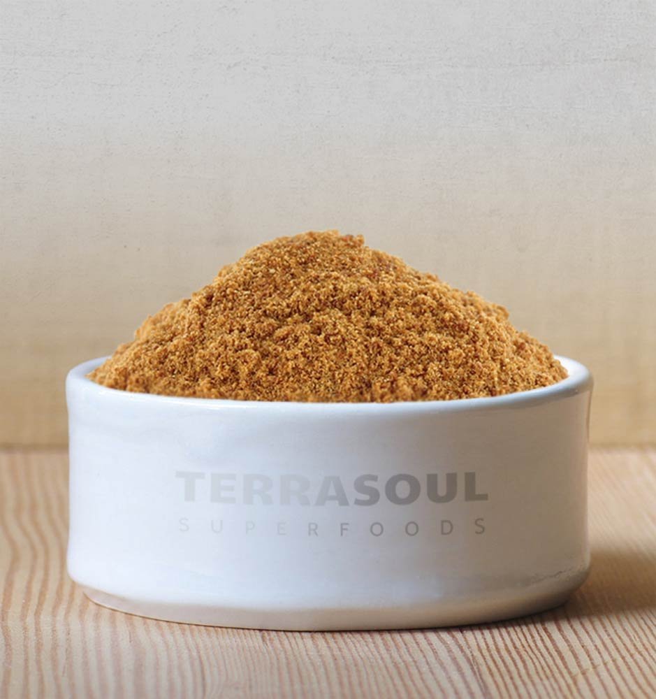 Teaspoon of Terrasoul Superfoods coconut sugar ready to sweeten coffee with caramel notes