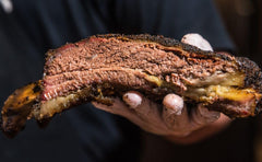 Terry Black's Barbecue rubbed brisket showing dark caramelized bark