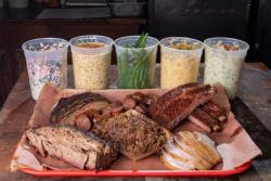 Terry Black's Barbecue jar beside tongs and spatula suggesting grilling