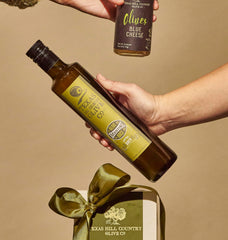 Pouring Texas Hill Country Olive Co. olive juice into a martini glass for bold flavor