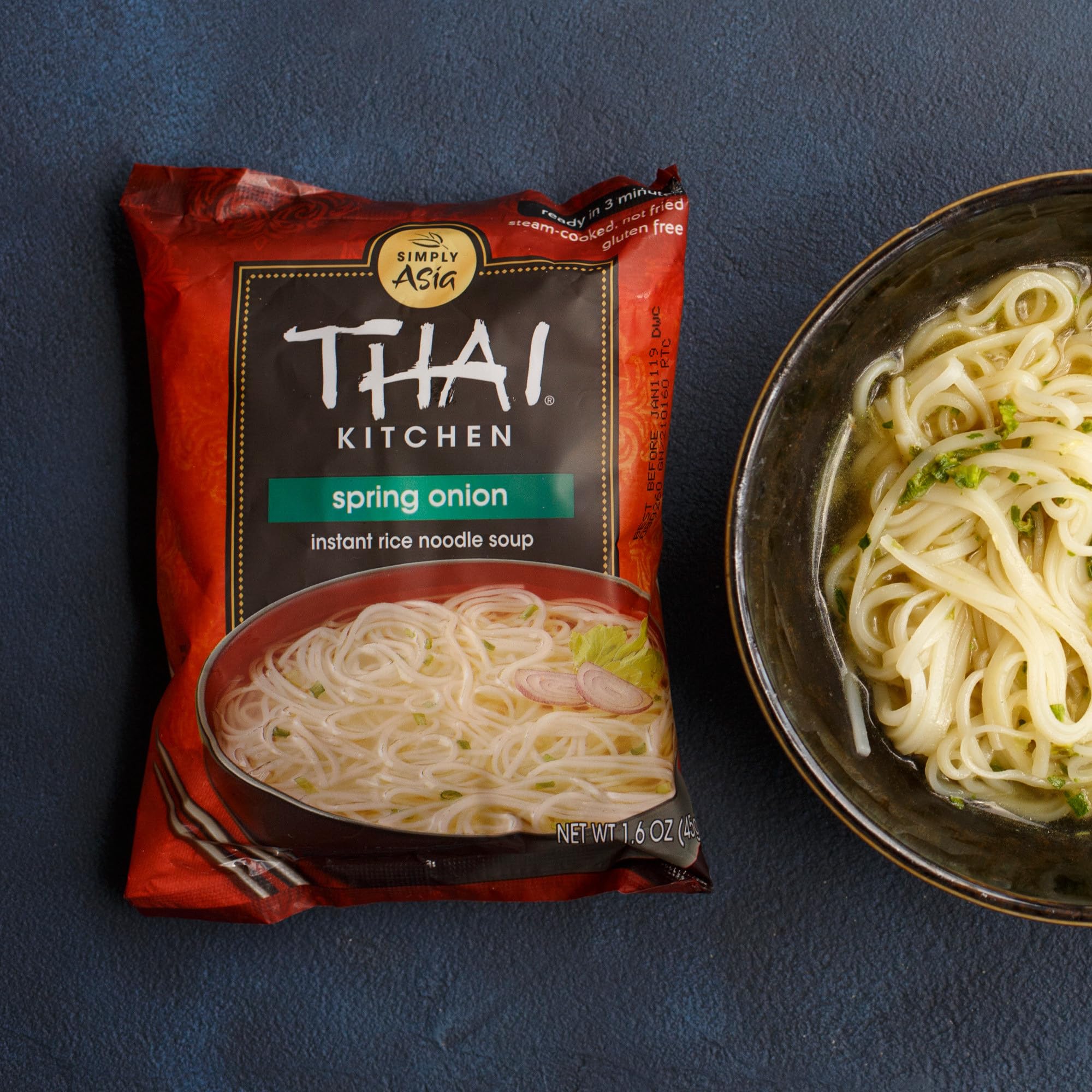 Hand holding Thai Kitchen cup to show scale, portable meal convenience demonstrated