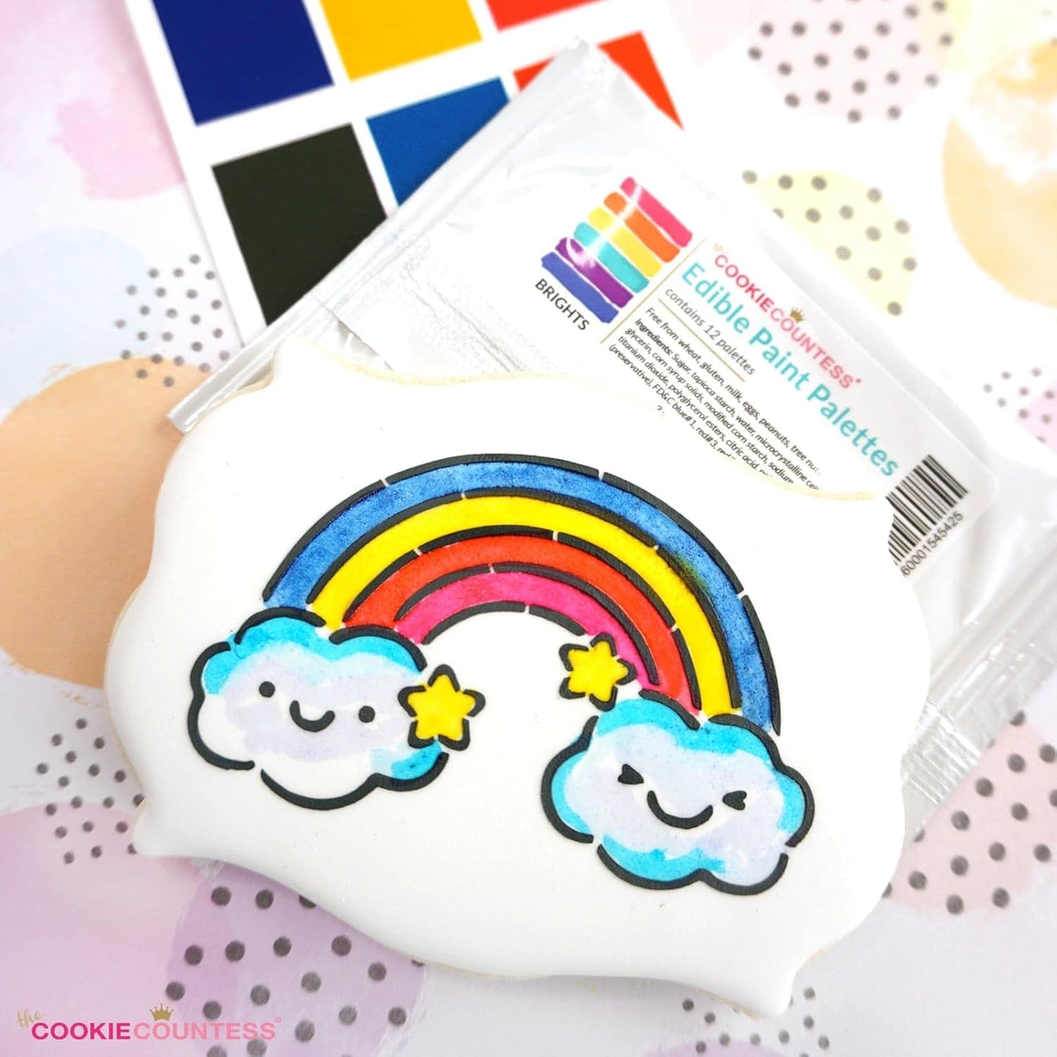The Cookie Countess brush applying paint to icing, highlighting smooth application benefit