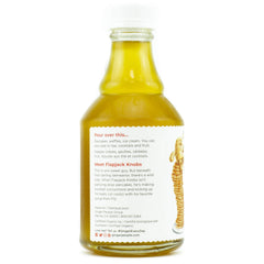 The Ginger People syrup poured into a cocktail glass adding bright ginger warmth and balance