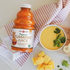Close-up of The Ginger People turmeric juice texture showcasing vibrant color