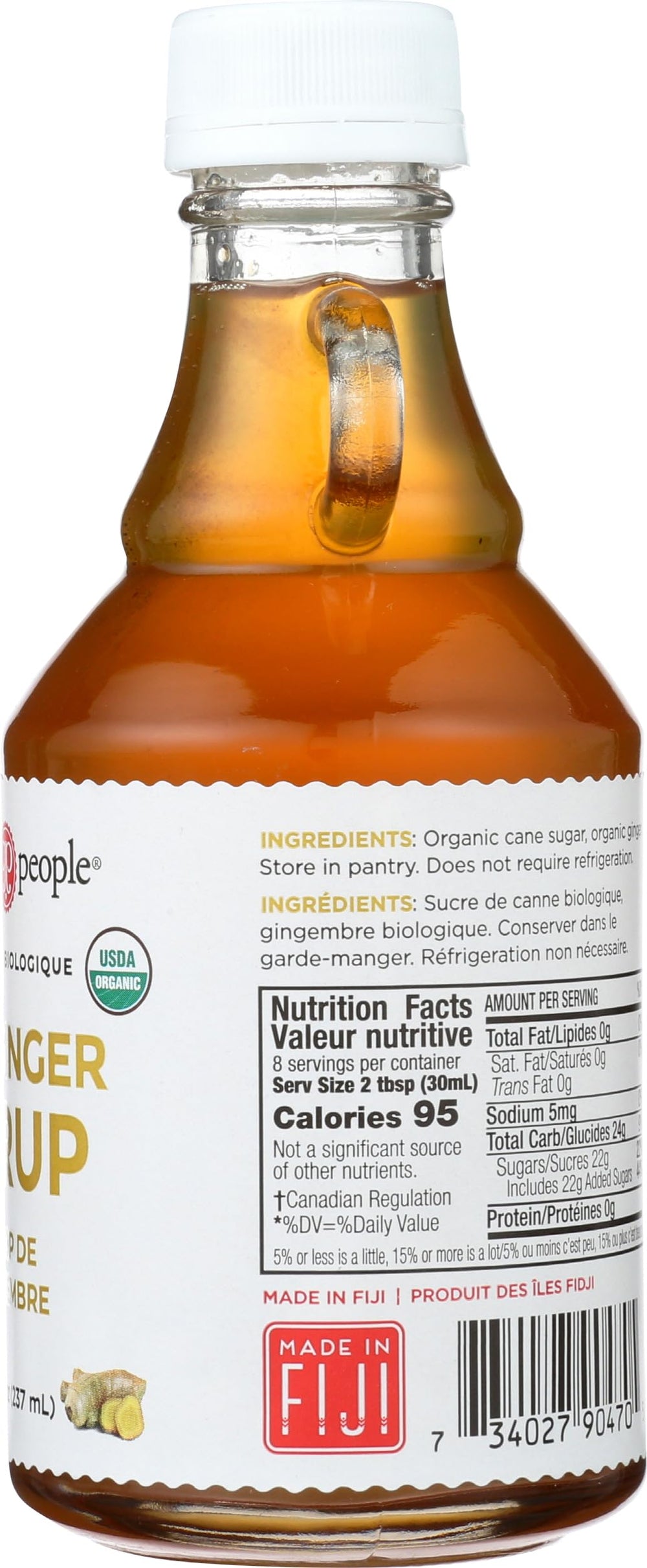 Hand holding The Ginger People 8 fl oz bottle showing portable size