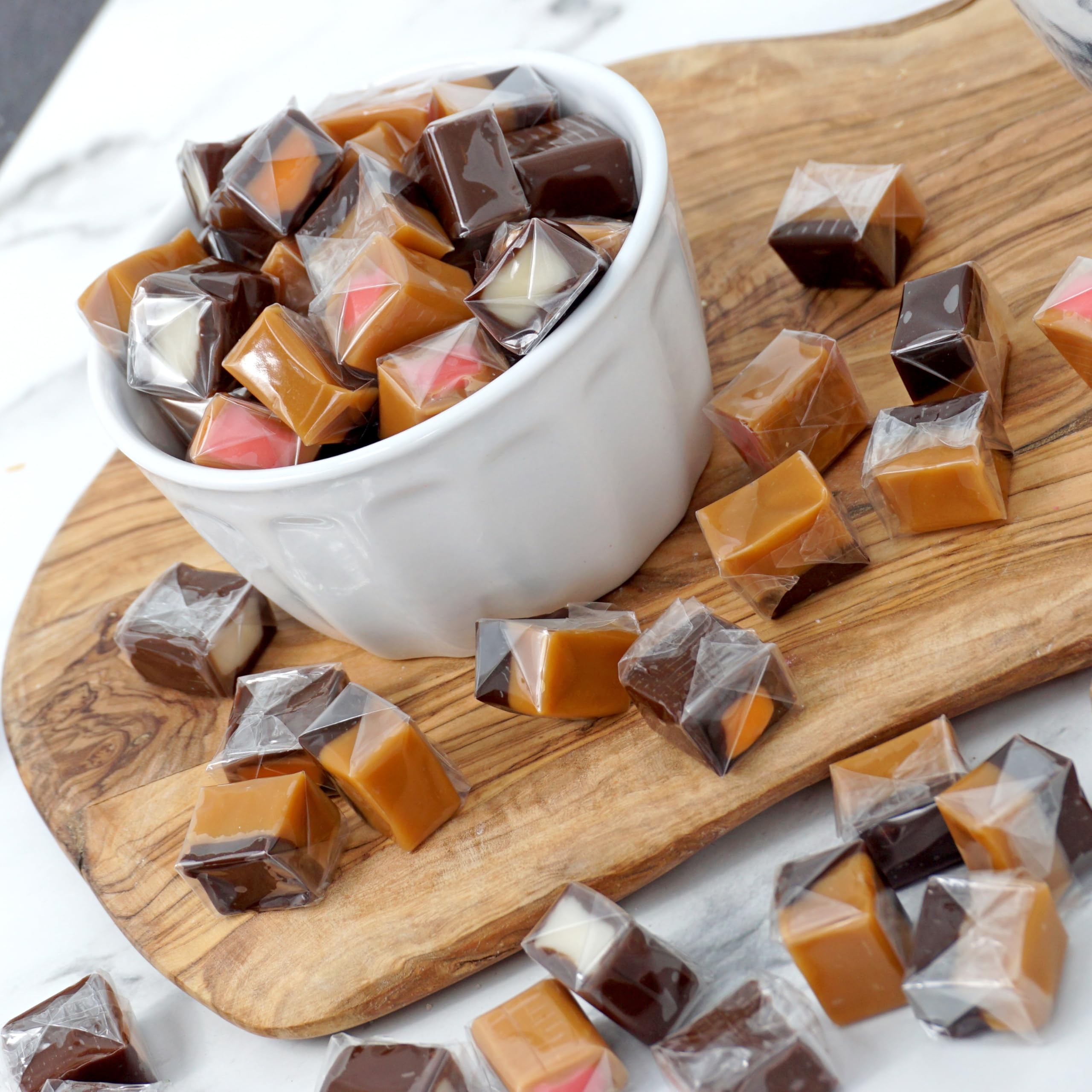 THE HAMPTON CANDY COMPANY caramel cube held in hand for size comparison and portion guidance