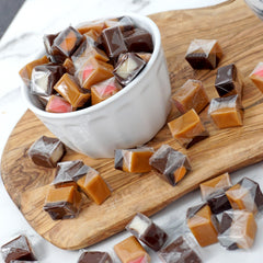 THE HAMPTON CANDY COMPANY caramel cube held in hand for size comparison and portion guidance