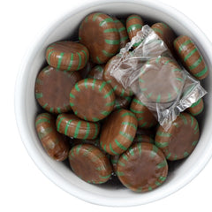 THE HAMPTON CANDY COMPANY hand holding one mint to show size and convenience benefit