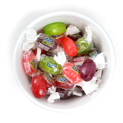 THE HAMPTON CANDY COMPANY Jolly Ranchers next to a smartphone to show compact size