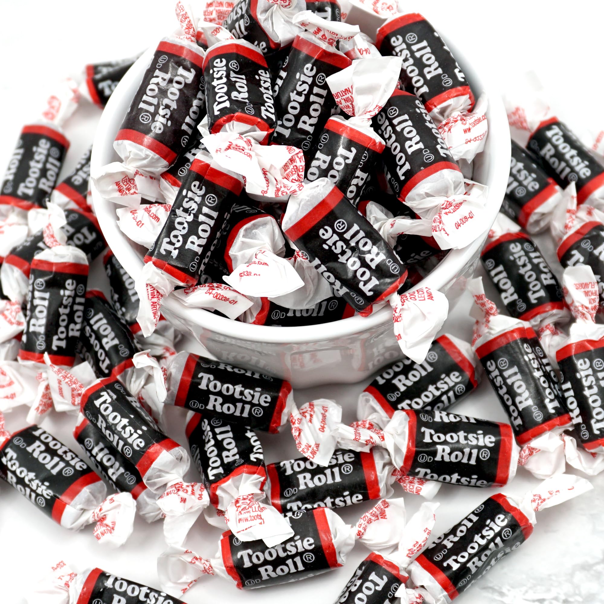 Close-up of Tootsie Roll Midgeee unwrap revealing chewy chocolate texture, The Hampton Popcorn quality visible