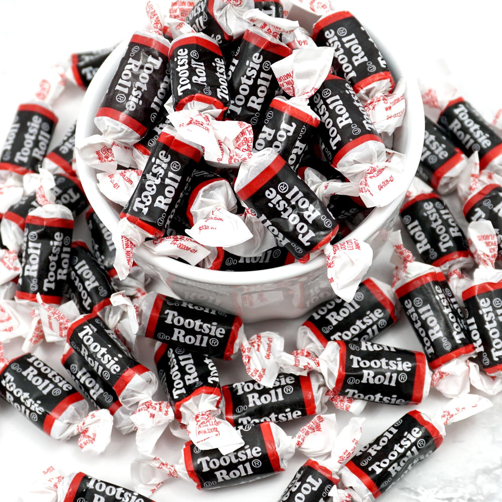 Close-up of Tootsie Roll Midgeee unwrap revealing chewy chocolate texture, The Hampton Popcorn quality visible