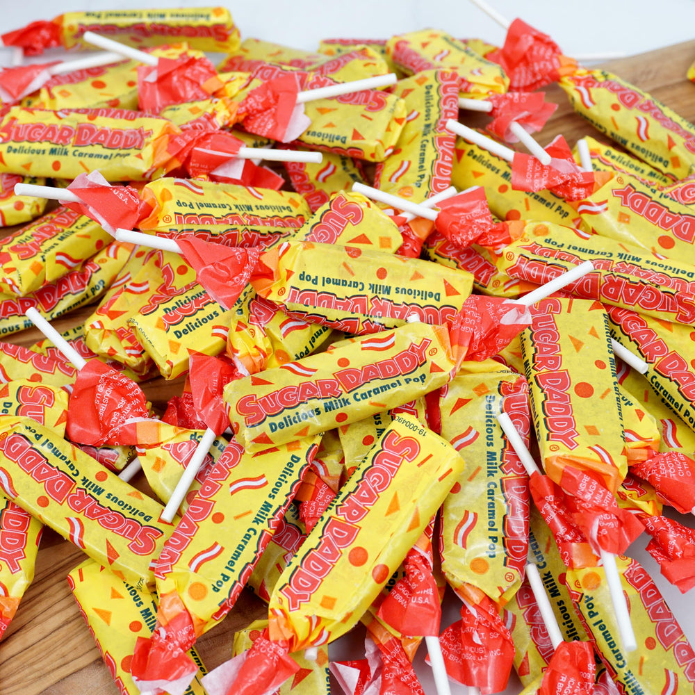 THE HAMPTON CANDY COMPANY pop in hand for size comparison and portioning benefit