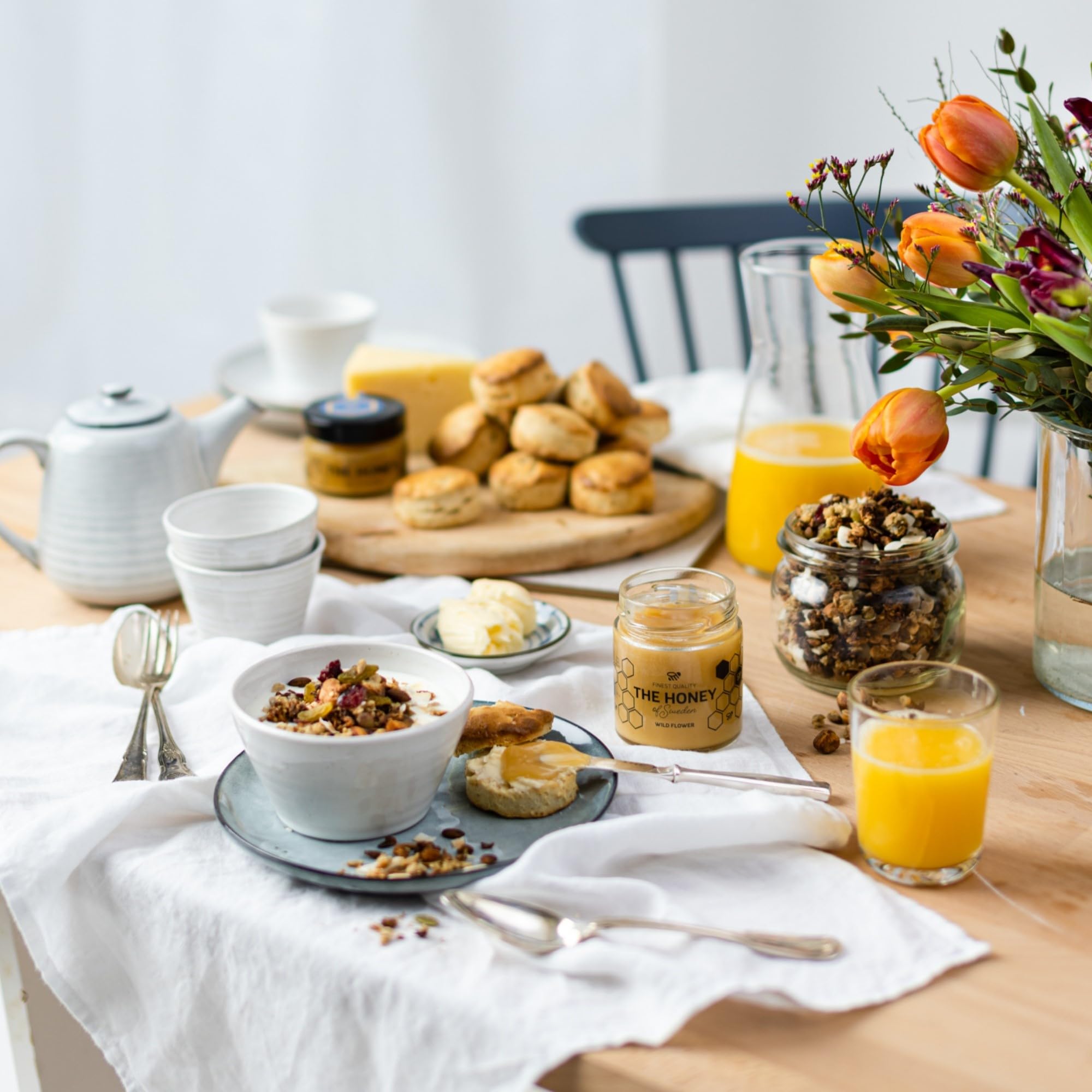 THE HONEY OF SWEDEN spoon with dripping honey emphasizing silky aroma and taste