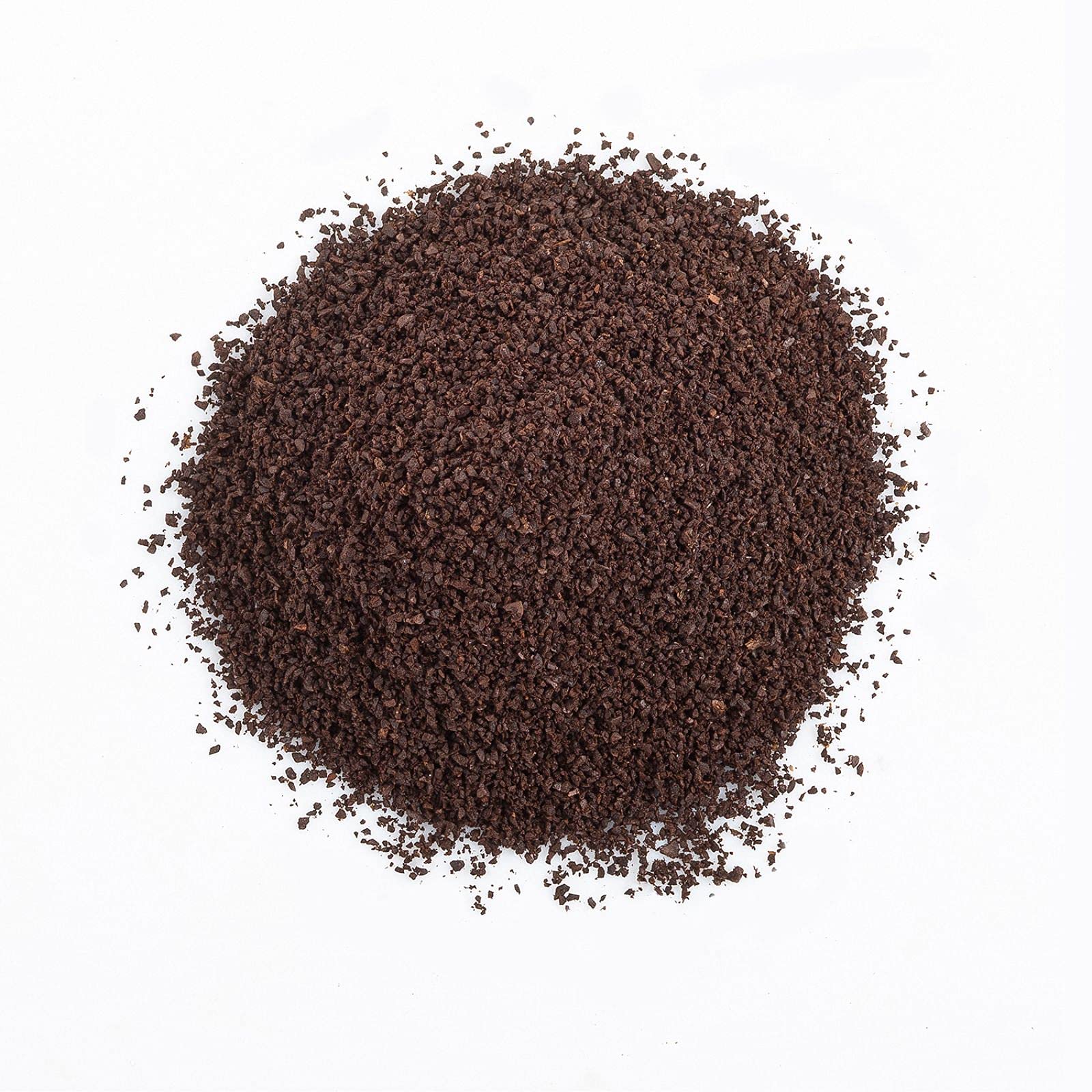 The Organic Coffee Co. grounds pouring to mug illustrating rich, balanced flavor