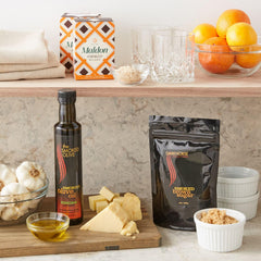 The Smoked Olive olive oil pouring close-up over shrimp, highlighting rich smoky flavor infusion