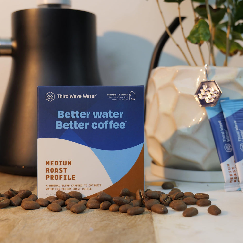 Third Wave Water stick beside a coffee bag to show scale and convenience for home brewing routines