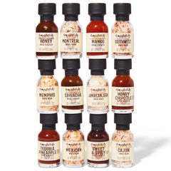 Thoughtfully lineup of mini glass bottles displaying labels and variety for comparing flavors