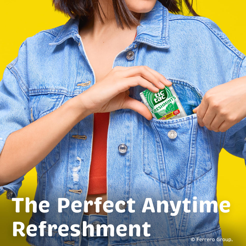 Tic Tac held in hand for scale illustrating pocket-sized convenience benefit