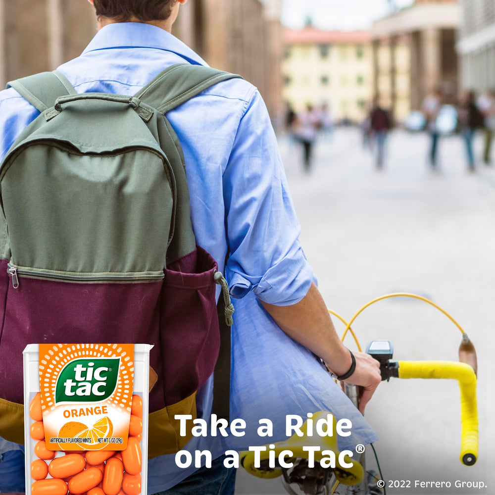 Tic Tac orange pack tucked in a jeans pocket illustrating portability and easy grab-and-go refreshment