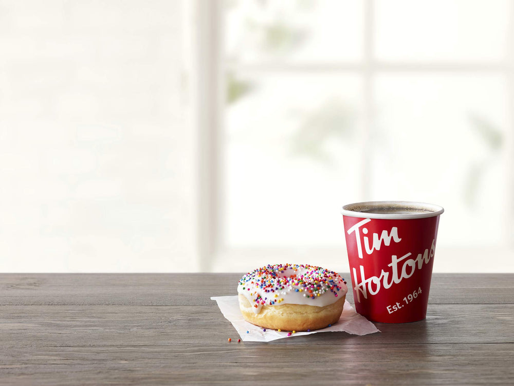 Tim Hortons Dark Roast pods inserted in a Keurig machine showing fast single-serve brewing