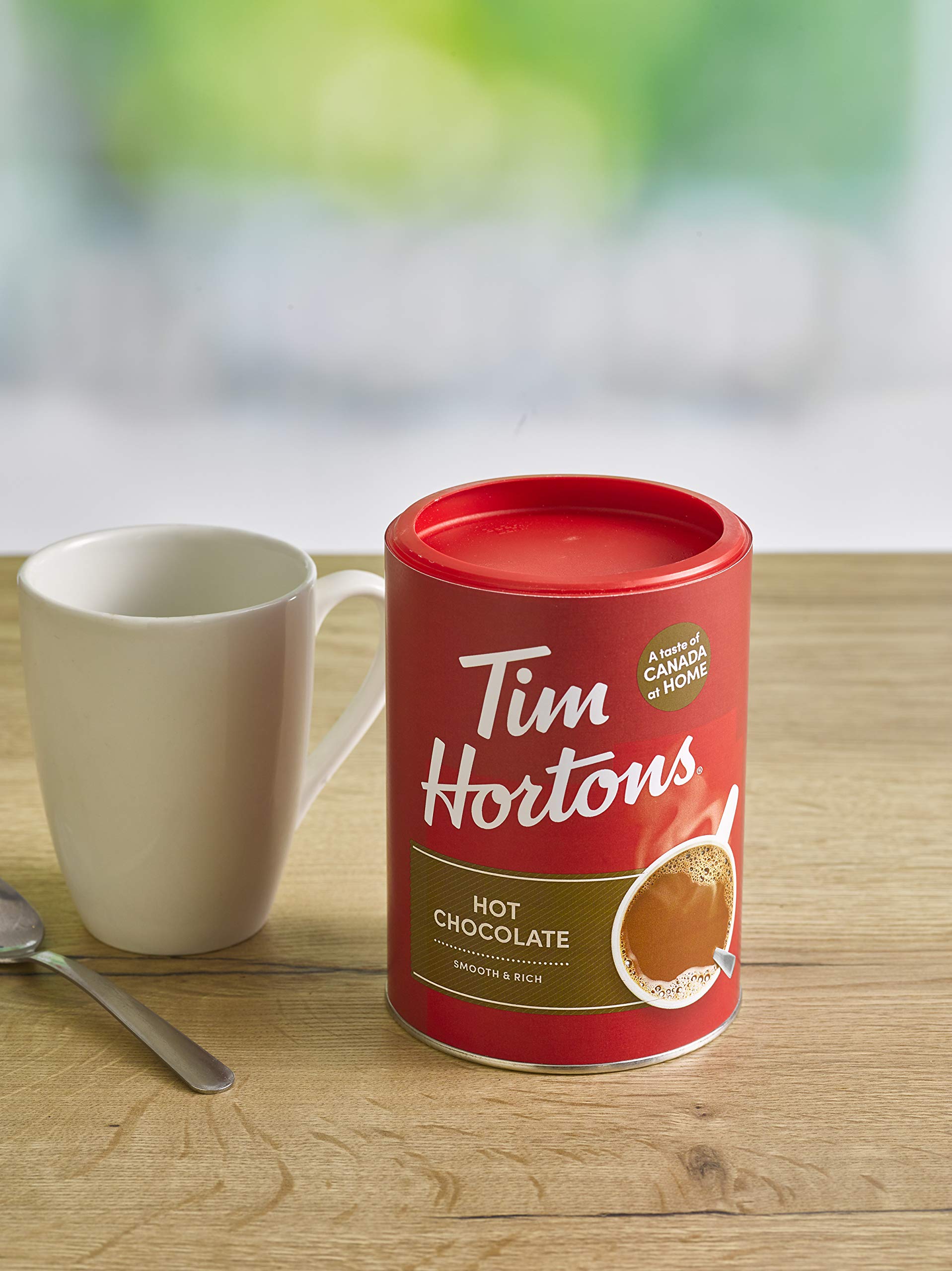 Tim Hortons hot chocolate package next to a mug to show scale and servings per container