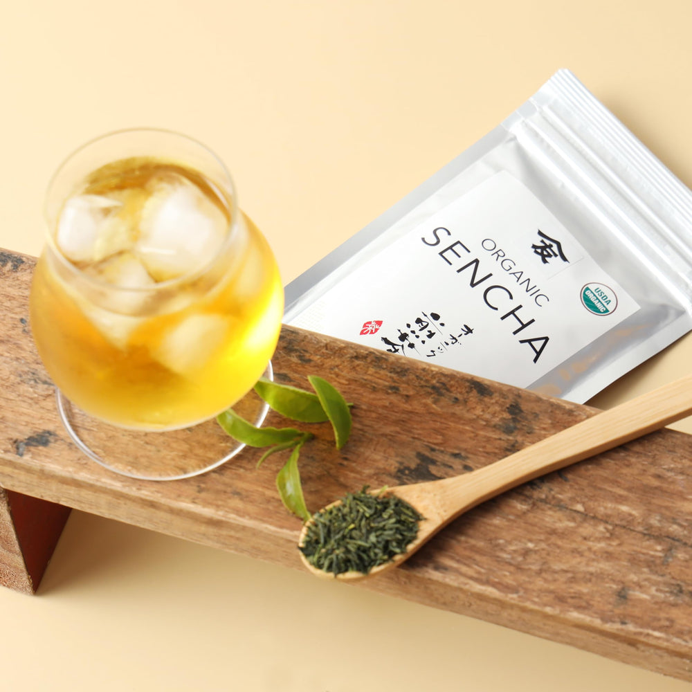 steaming brewed cup of TOMOSAN sencha showcasing bright green liquor and clarity