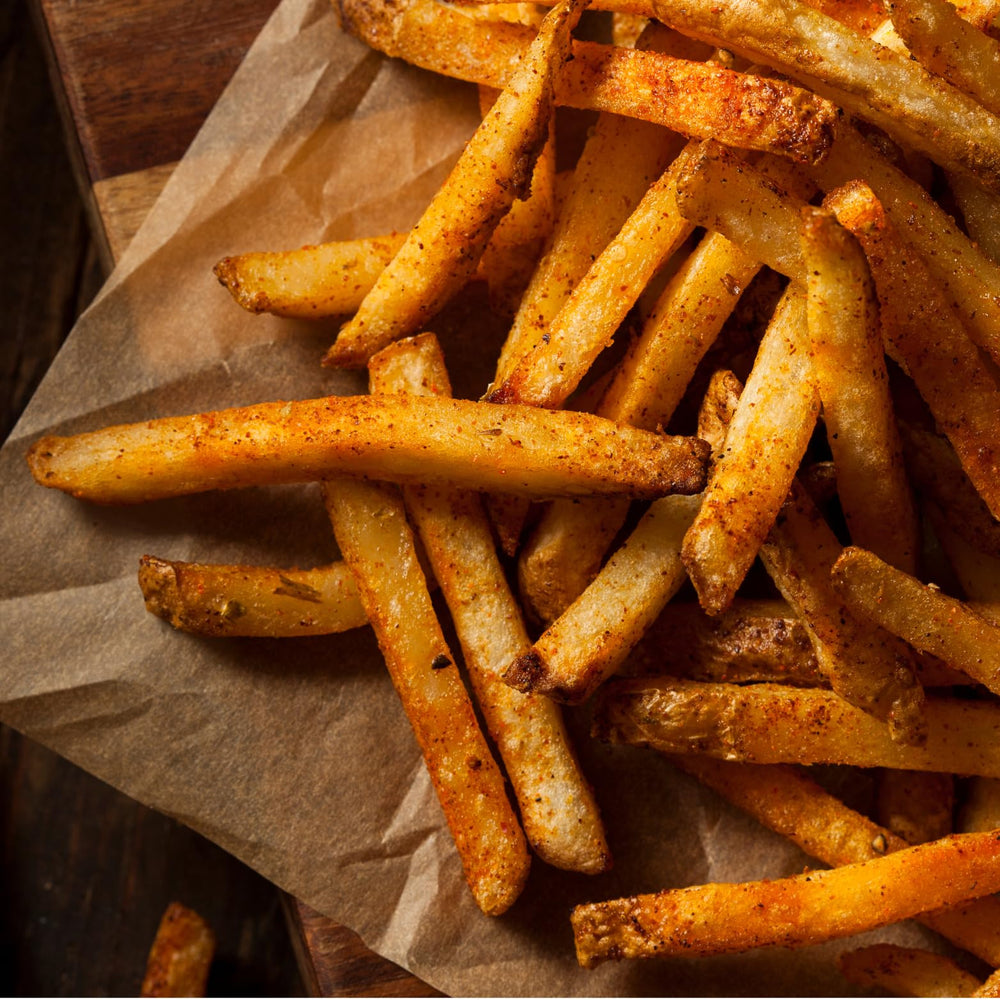 Tony Chachere's seasoned French fries plated for enhanced snack flavor