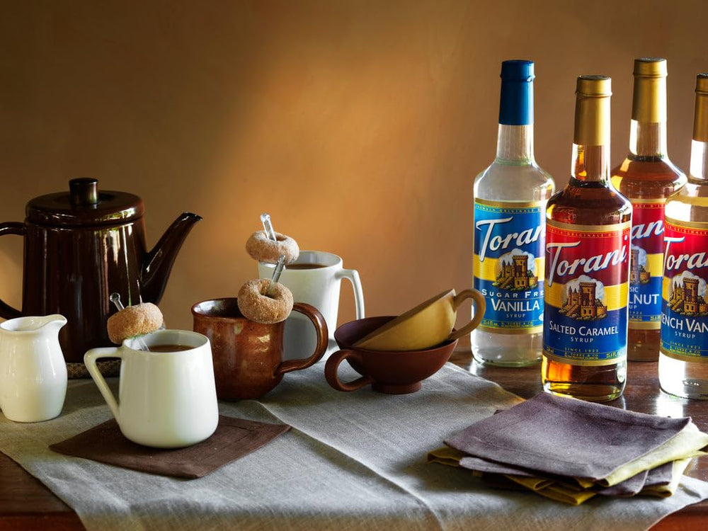 Torani Mojito Mint bottle on a bar counter with tools, conveys professional use
