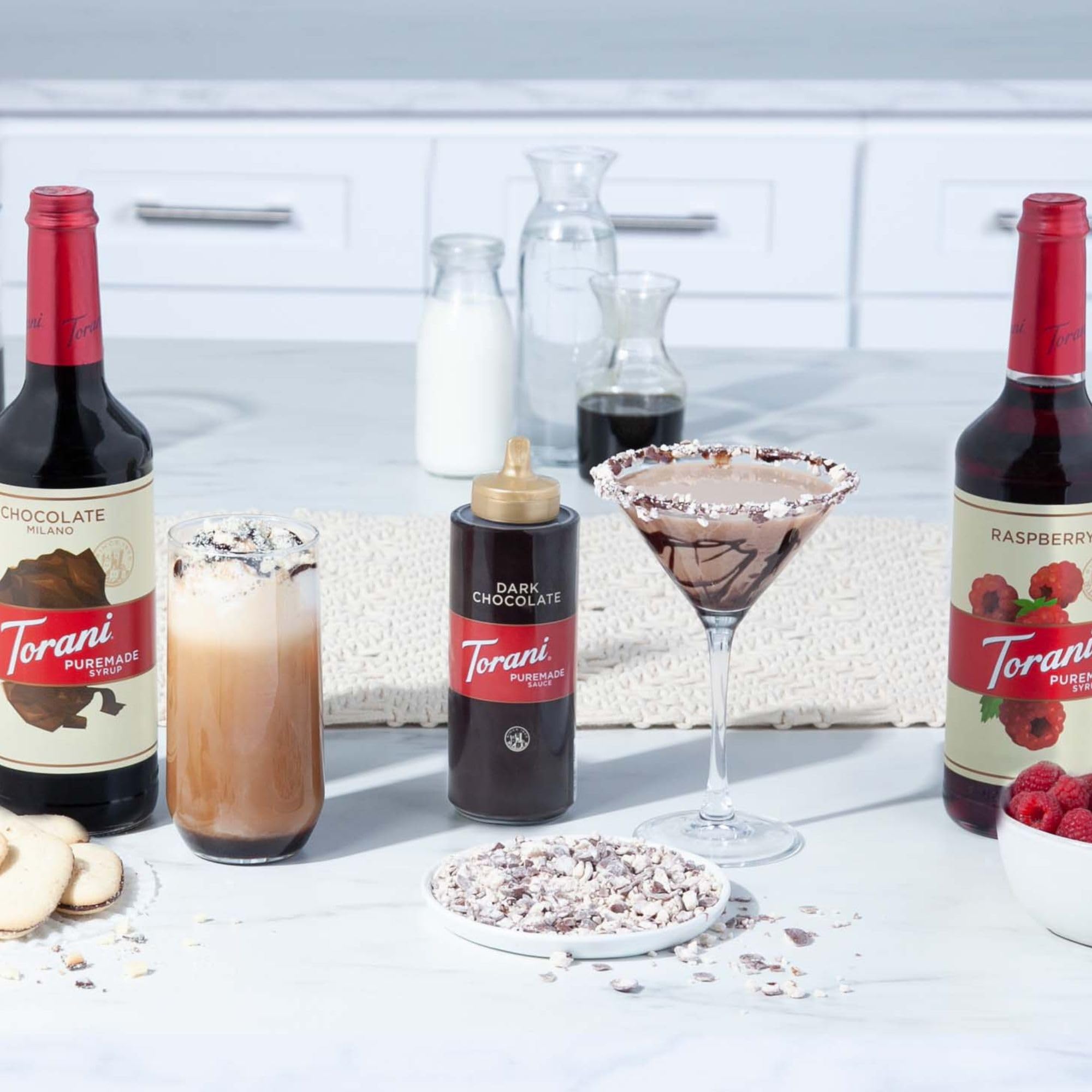 Four-pack comparison next to a measuring cup showing Torani size and volume practicality