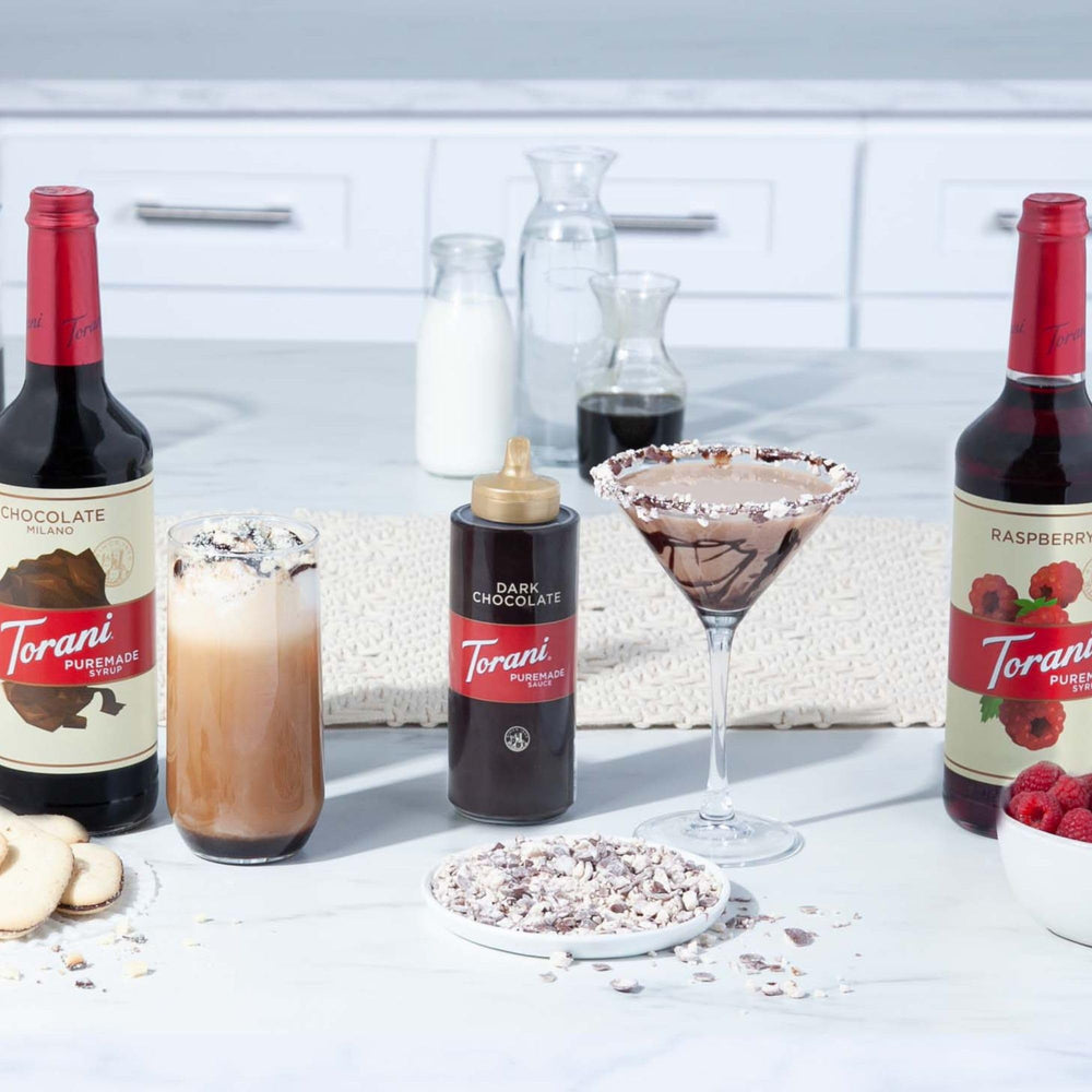 Four-pack comparison next to a measuring cup showing Torani size and volume practicality