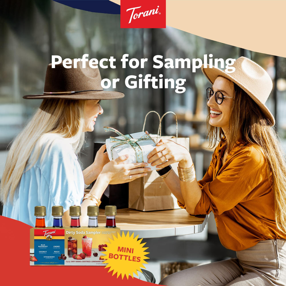 Hand holding Torani mini bottle illustrating portable size and travel convenience
