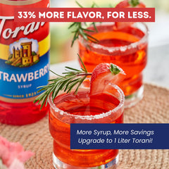 Torani syrup pouring over iced drink adding vibrant strawberry flavor and color