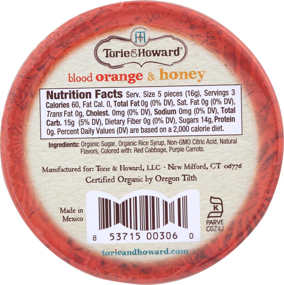 Torie & Howard tin held in hand to show 2-ounce scale and portability