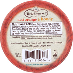 Torie & Howard tin held in hand to show 2-ounce scale and portability