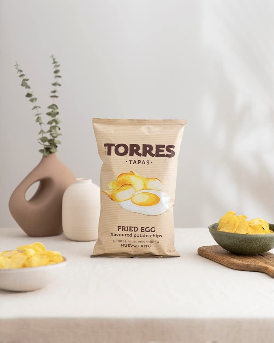 Torres Selecta on a tapas plate beside olives and cheese suggesting party pairing