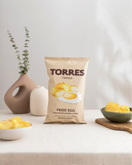 Torres Selecta on a tapas plate beside olives and cheese suggesting party pairing