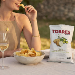 TORRES Selecta held in hand to demonstrate single-serve pack portability benefit