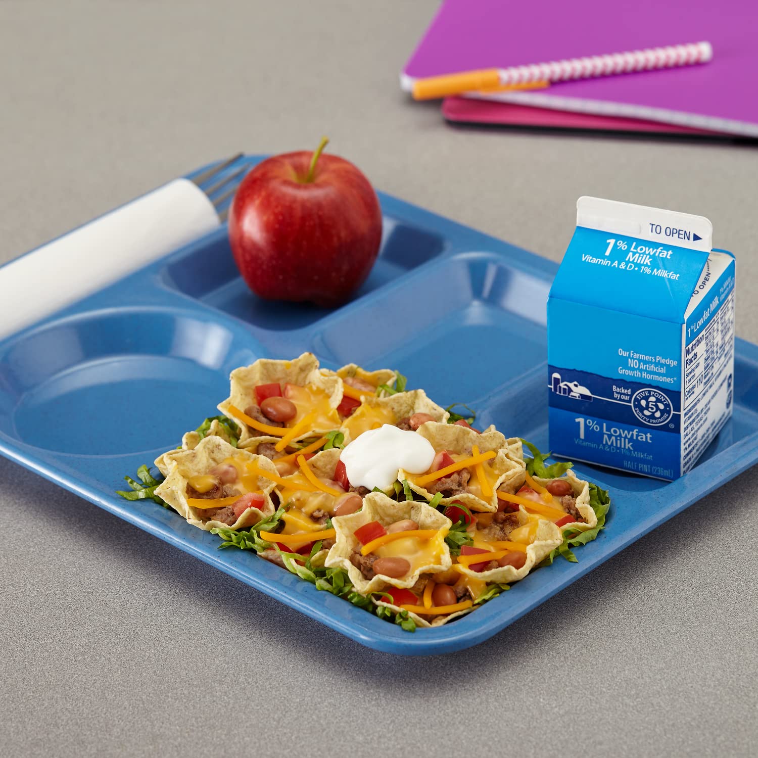 Hand holding a Tostitos scoop dipping into salsa demonstrating scoop shape benefit