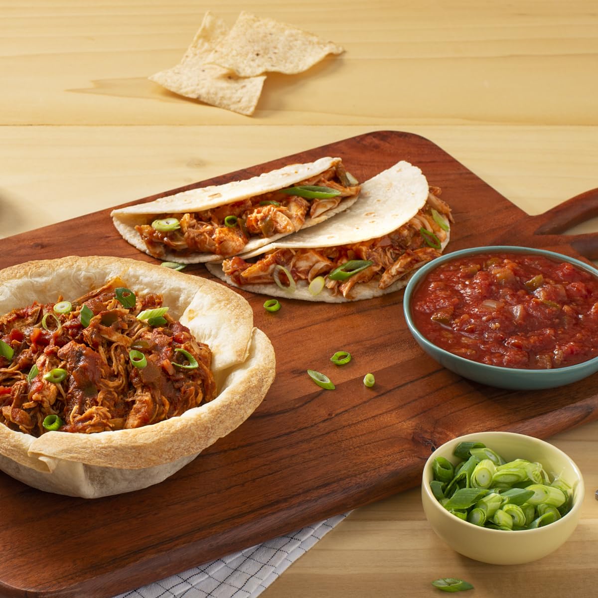 Tostitos jars next to a hand showing 15.5 oz scale and portion clarity benefit