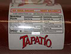 Trader Joe's Tapatio bottle poured over tacos in kitchen, adding tangy pepper flavor