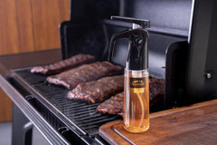 Traeger spritzer hanging on Traeger P.A.L. rail for handy access while grilling